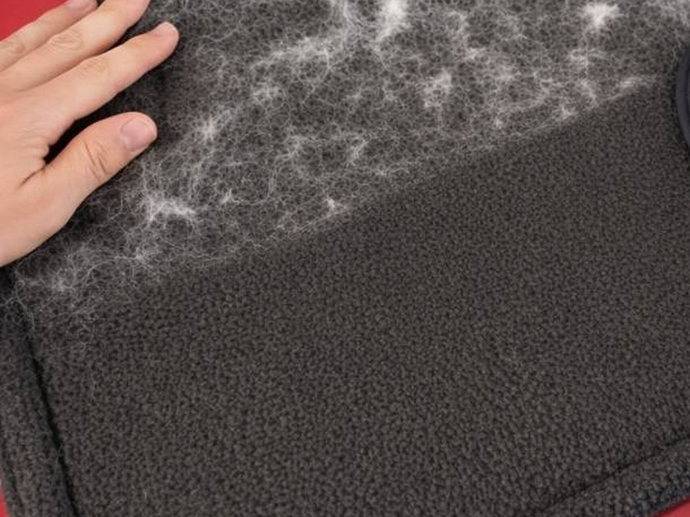 Furvia glove on laundry fabric with loose pet hair