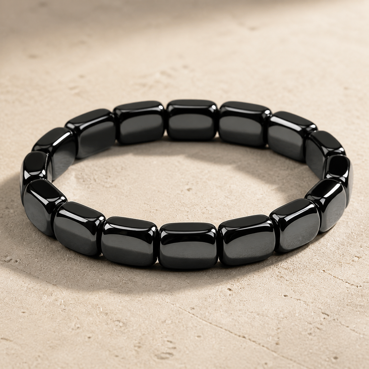Dravyn black tile-bead bracelet on pale stone