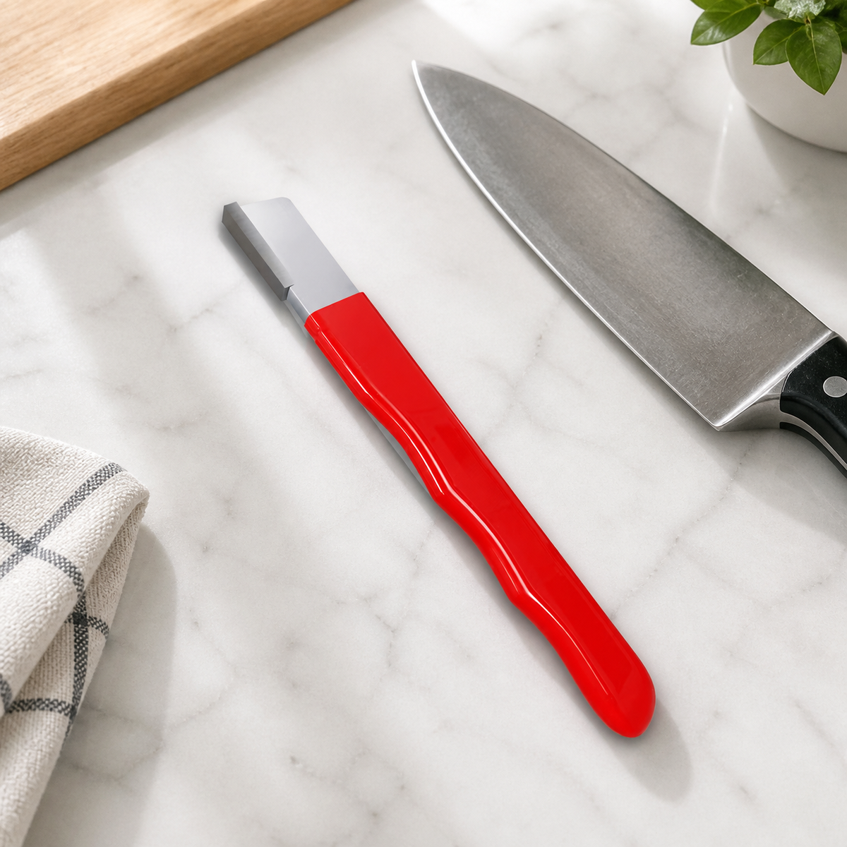 EdgeSharp on a kitchen counter beside a chef knife