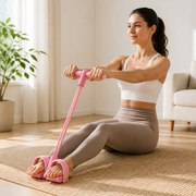 Woman performing a seated Kinava exercise with both feet in the pedal loops and both hands on the single handle