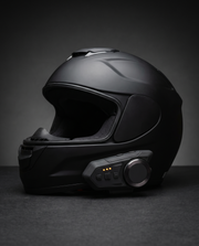 Rydvox V10 mounted on a matte black motorcycle helmet