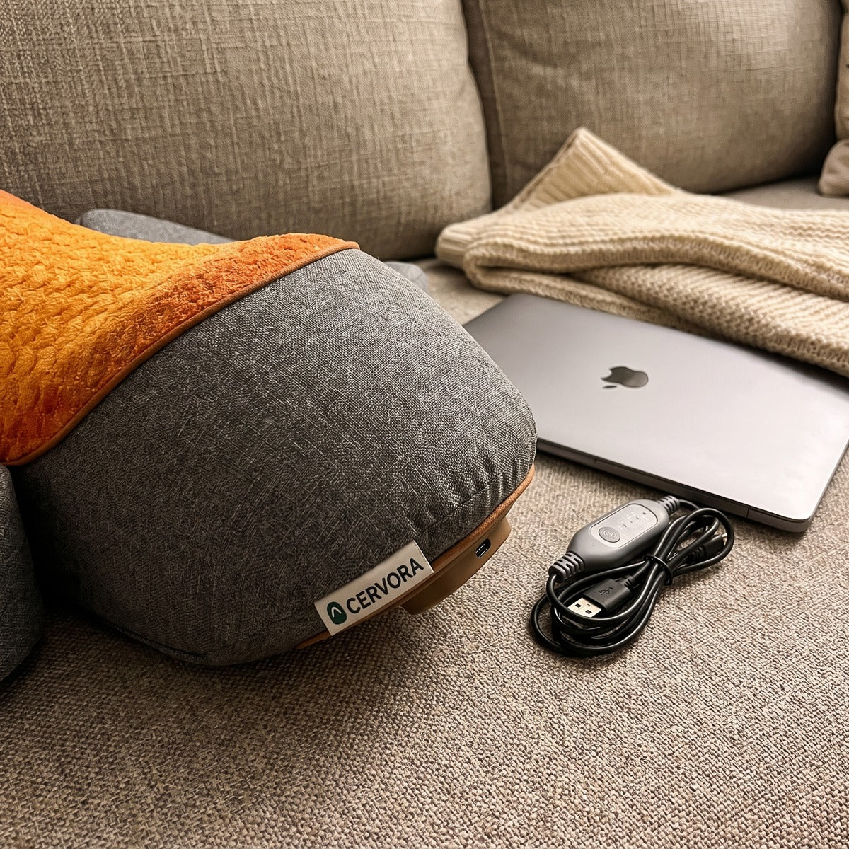 Cervora heated neck pillow beside a laptop after work