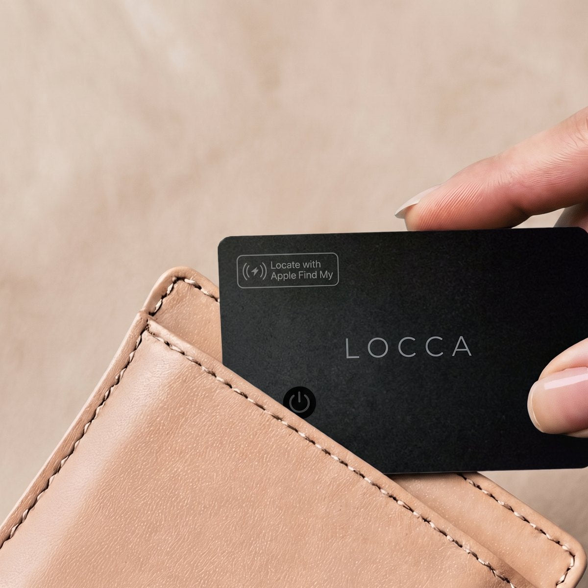 Slipping a slim Locca tracking card into a leather wallet