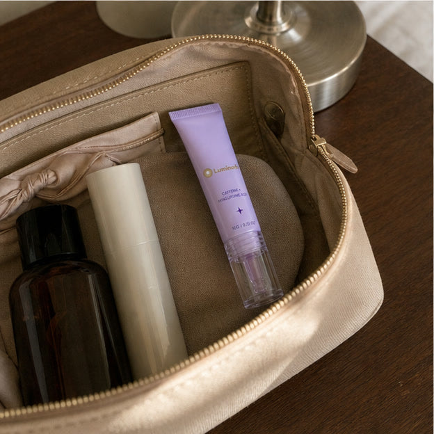 Representative travel-pouch scene showing one compact Luminorb roller tube